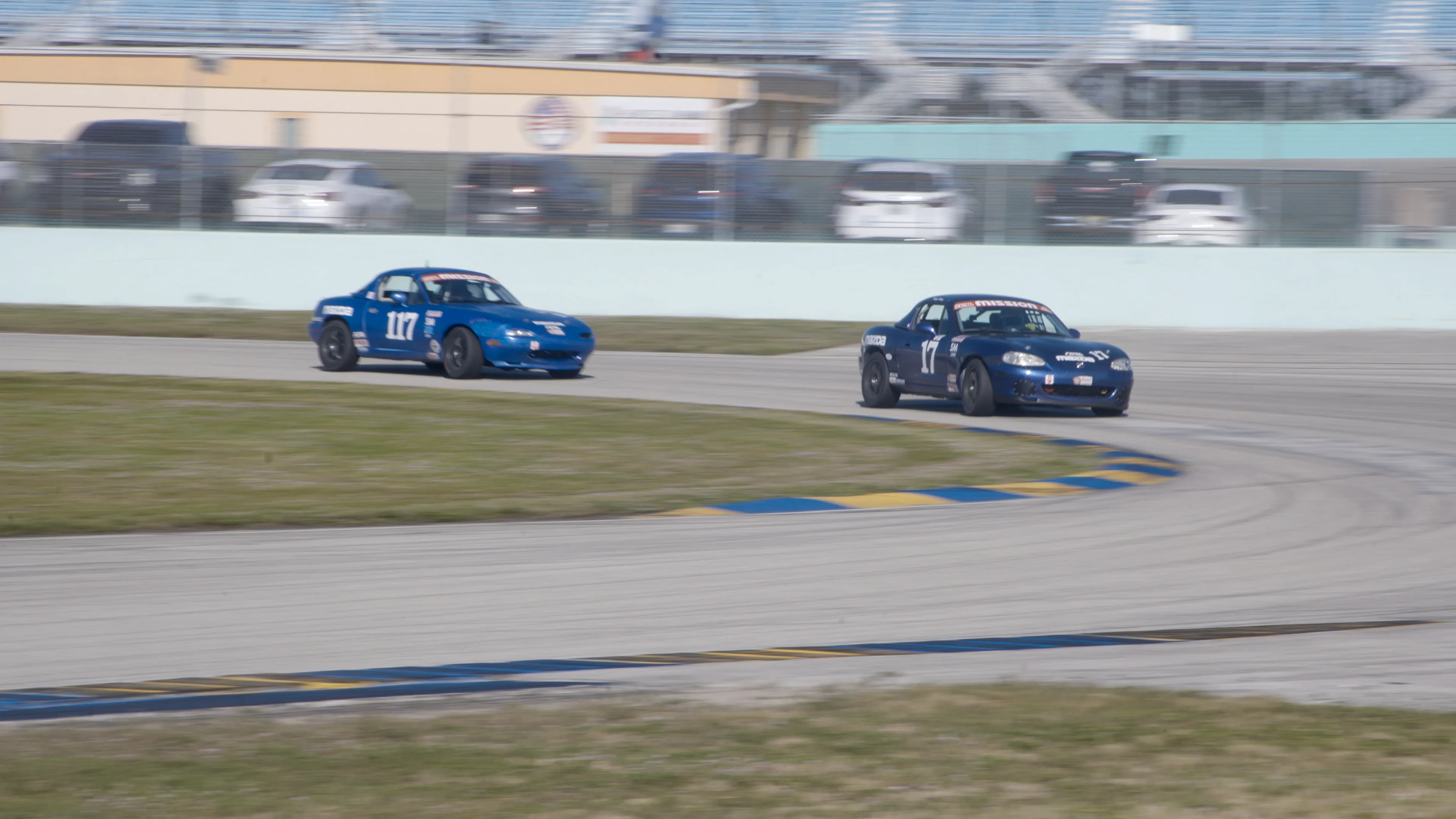 Miatas battling through corner