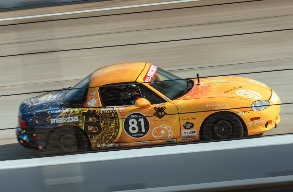 Panning shot of the Bitcoin livery at speed